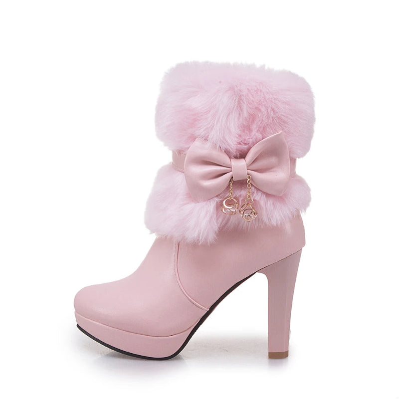 Pink high-heeled boot with fluffy top and bow detail on a white background