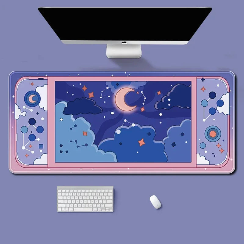 A large desk mat with a pastel night sky illustration, shown on a lavender desk with a computer monitor, keyboard, and mouse.