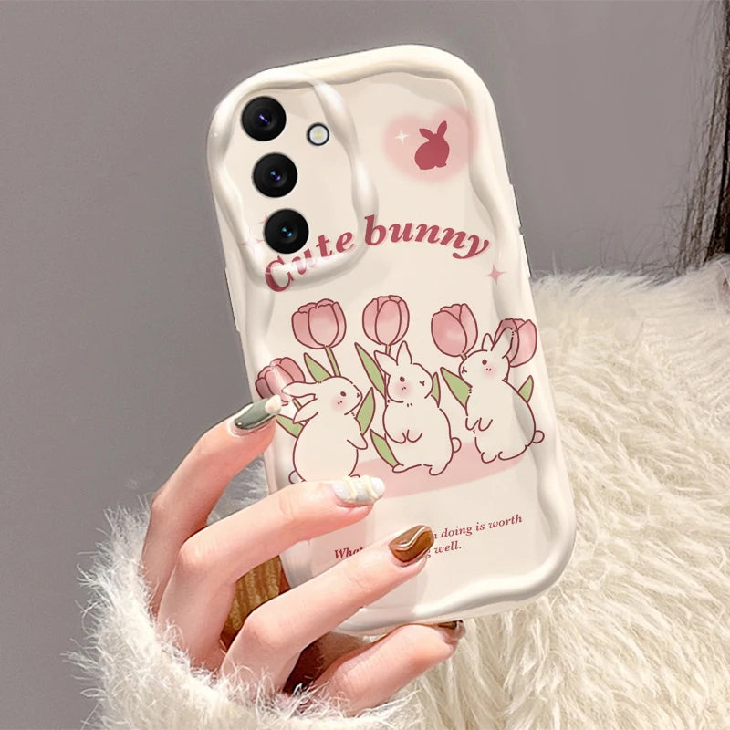 Phone case with cute bunny design held by a hand against a gray background
