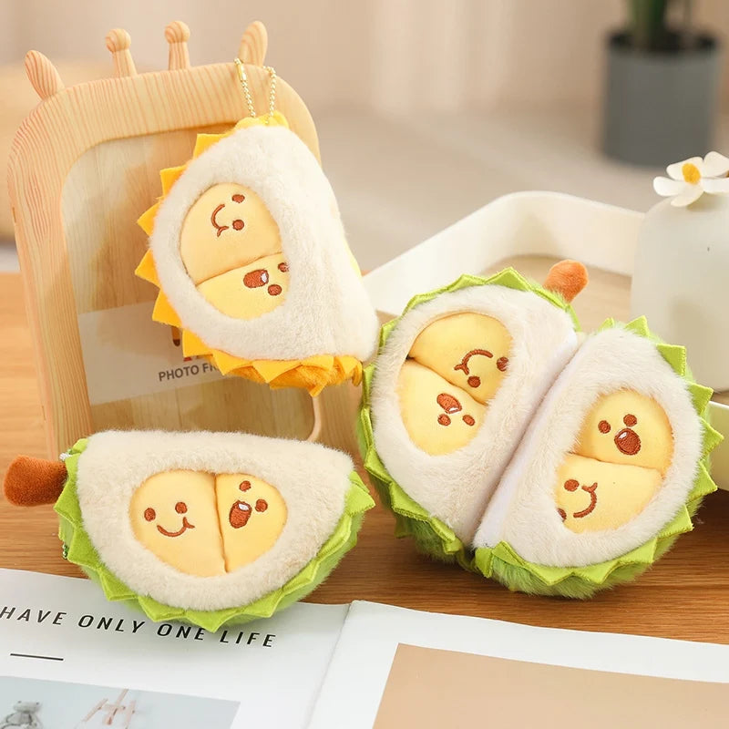 Plush toys shaped like durian items on a wooden surface.