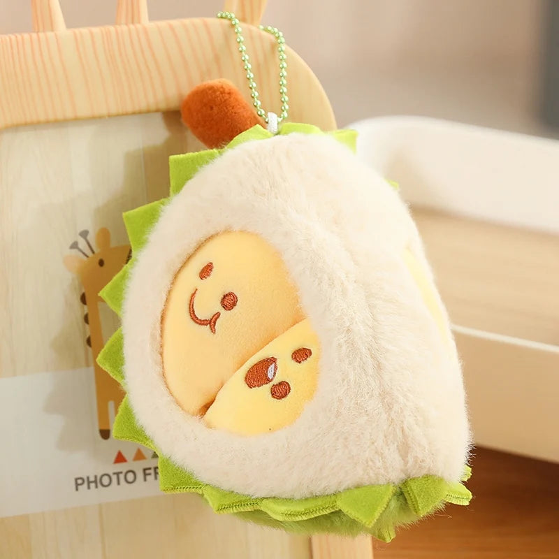Plush durian keychain with a smiling face on a blurred background