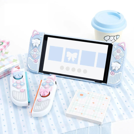 Nintendo Switch console with screen, remote controls, and stationery on a polka dot surface