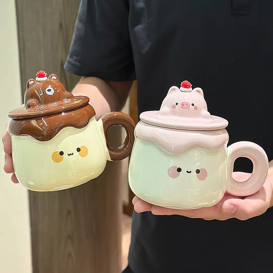 Two Kawaii Animal Pudding Ceramic Mugs being held by a person in a black t-shirt