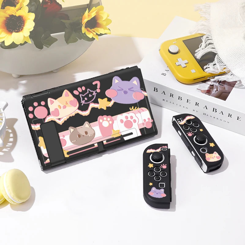 Black phone case with cartoon cat designs on a white surface with a yellow flower arrangement.