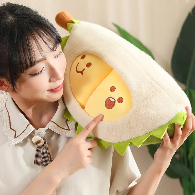 Person holding a plush durian toy with a smiling face