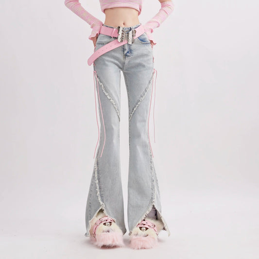 Person wearing light blue jeans with pink accents on a white background