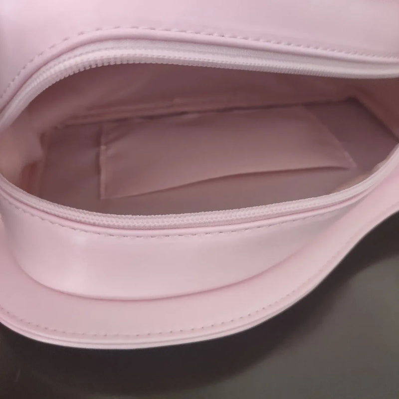 Close-up of a pink bag with a zipper on a dark surface