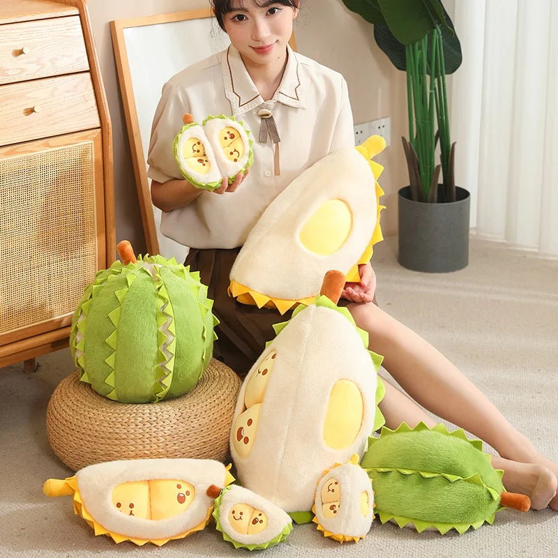 Person holding and posing with durian plush toys in a room.