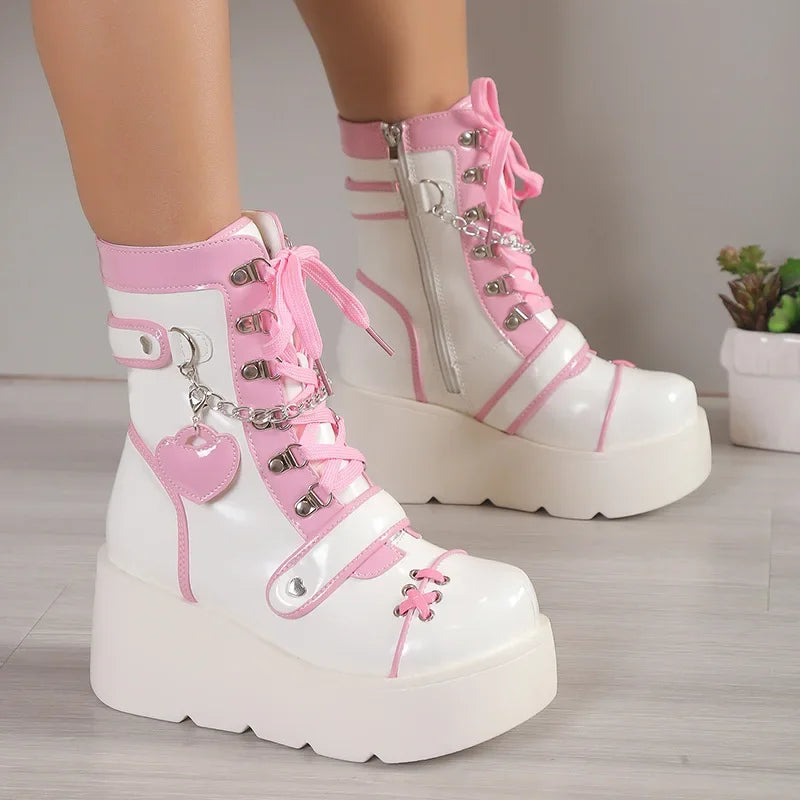 White and pink platform boots with decorative elements on a neutral background