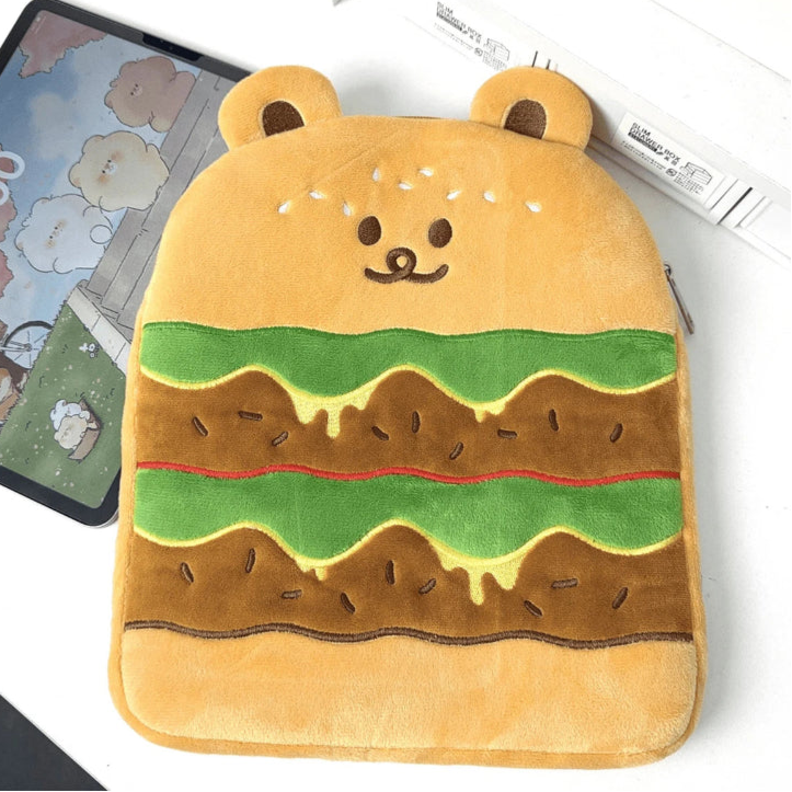 Hamburger-shaped tablet sleeve with bear ears on a desk next to a tablet
