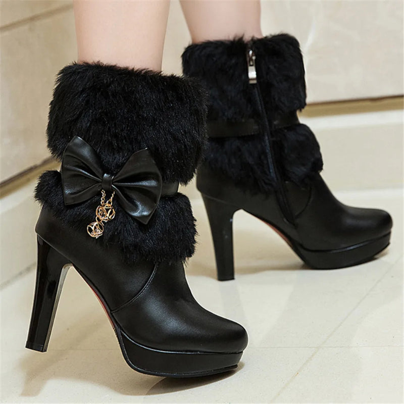 Black high-heeled boots with fluffy tops and a bow detail on a light background