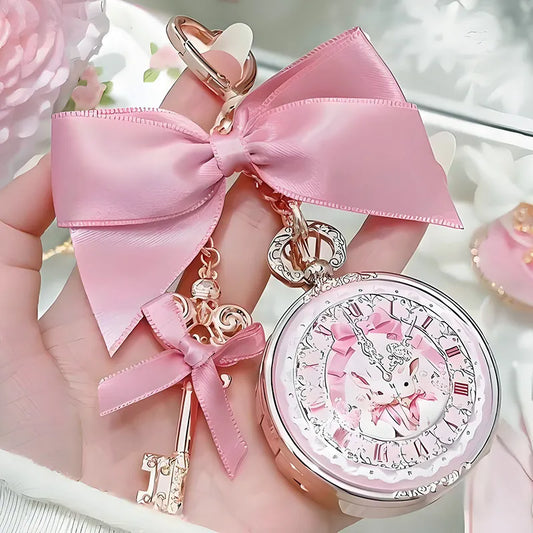 kawaii lip balm with pink ribbon and decorative elements held in a hand against a soft background.