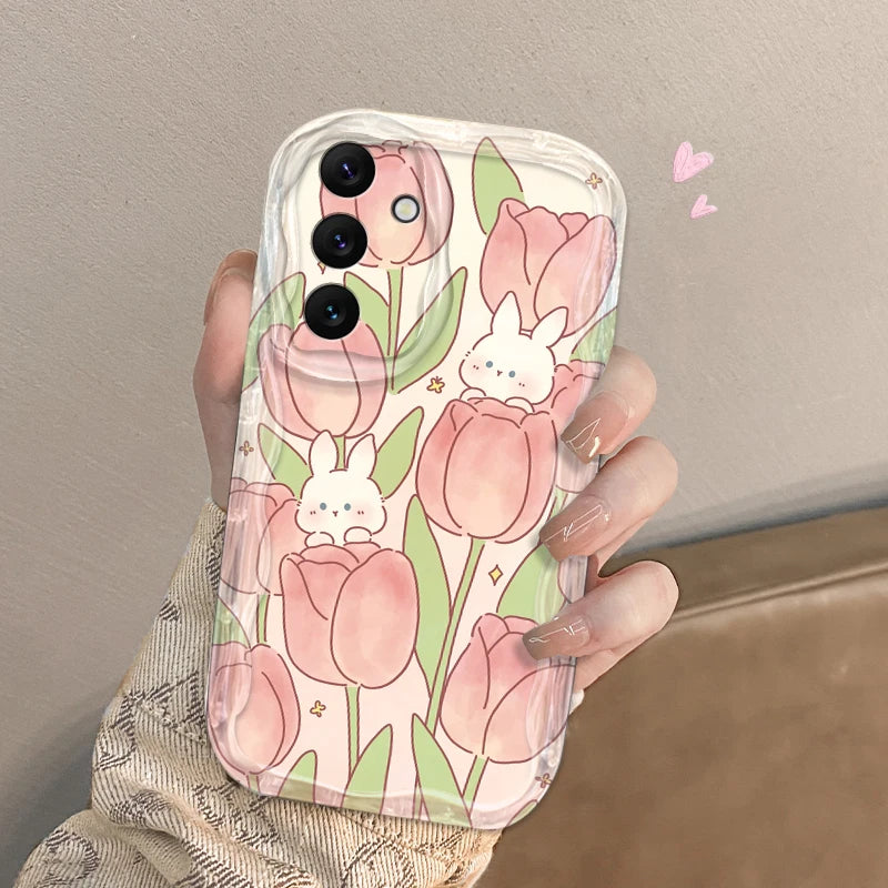 Phone case with tulip and bunny design held by a hand against a neutral background