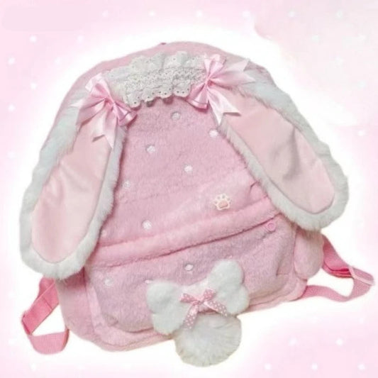 Pink backpack with bunny ears and bow on a light pink background