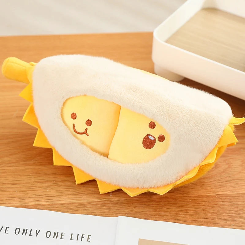 Plush toy resembling a durian with a face on a wooden surface