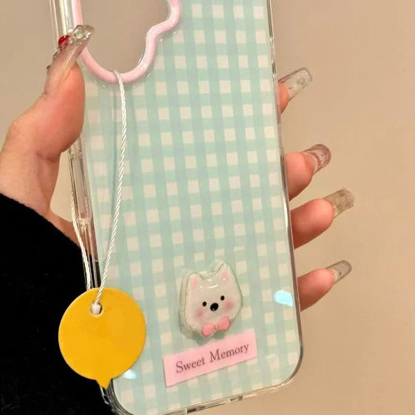 Phone case with checkered pattern, cartoon dog, and 'Sweet Memory' text held by a hand.
