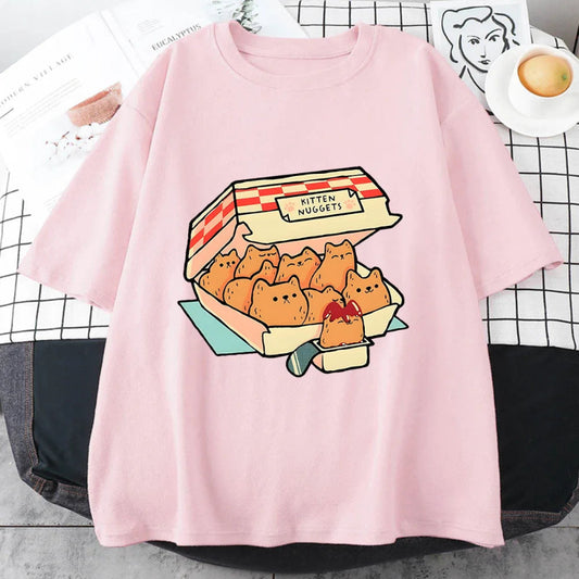 Pink t-shirt with a cartoon design of kitten nuggets on a checkered tablecloth.