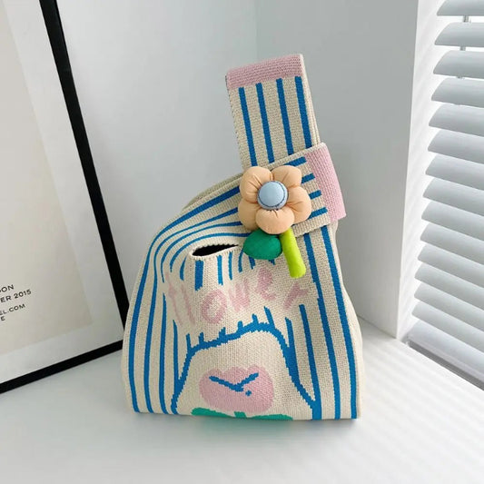 Striped pouch with floral design and 'love' text on a white surface
