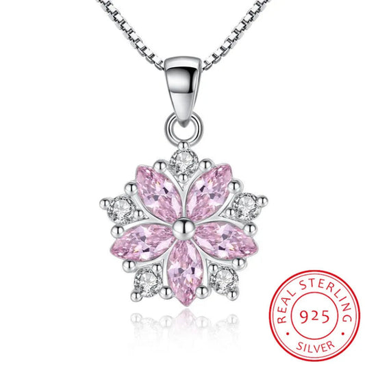 Sakura Cherry Blossom Necklace the light pink version is hanging on a white background with a sterling silver chain