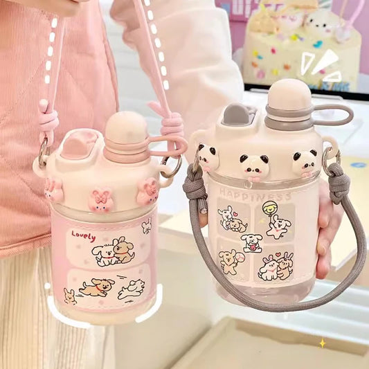 Two cute water bottles with cartoon designs held by a person.