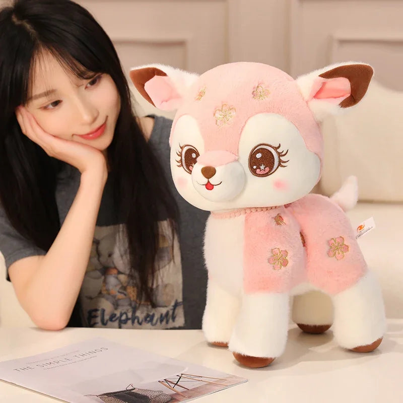 Woman admiring a pink deer plushie on a desk