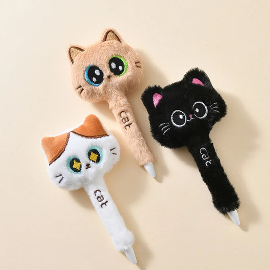 Three cat-shaped pens on a beige background