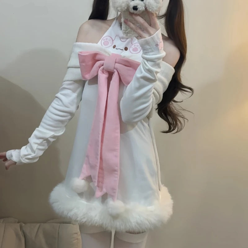 Person wearing a white outfit with a pink bow and holding a cell phone