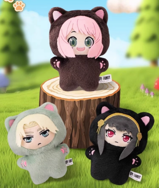 Three plush toys with animal ears on a grassy background