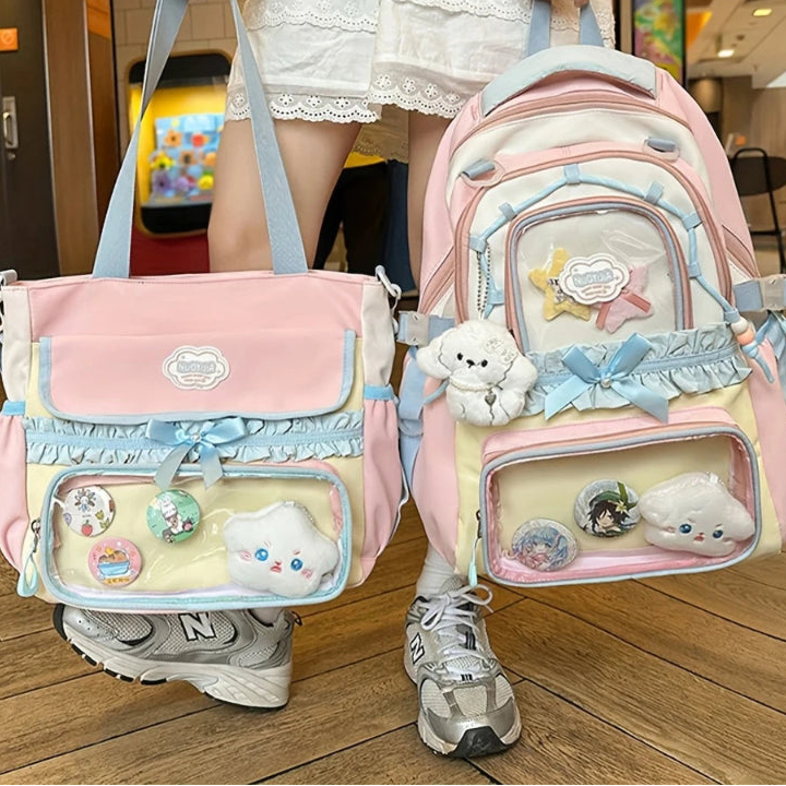 Person holding two decorative bags with various embellishments in an indoor setting.