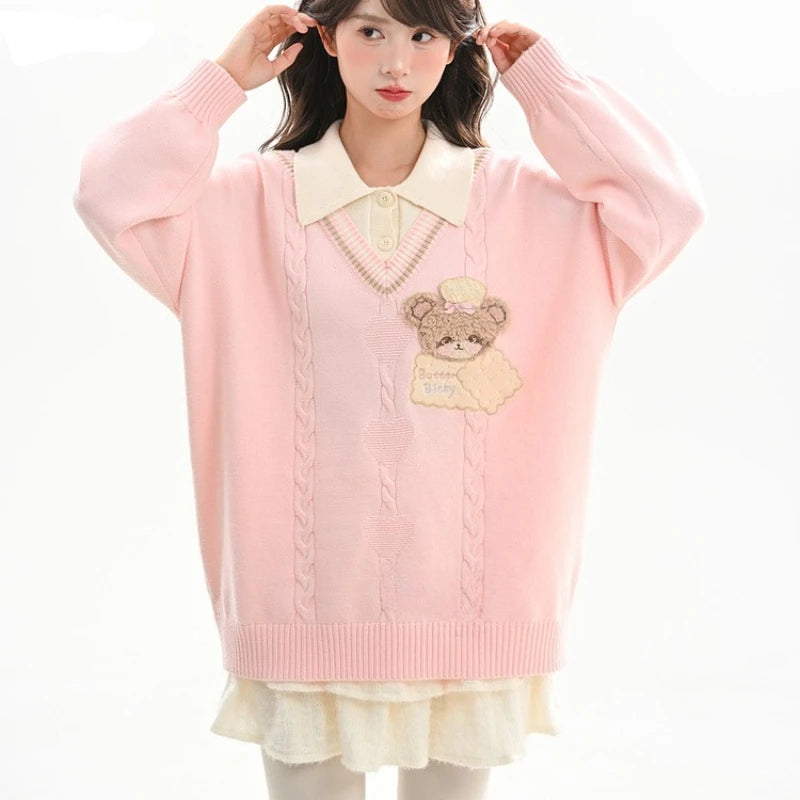 Woman wearing a pink sweater with a teddy bear design and white collar.