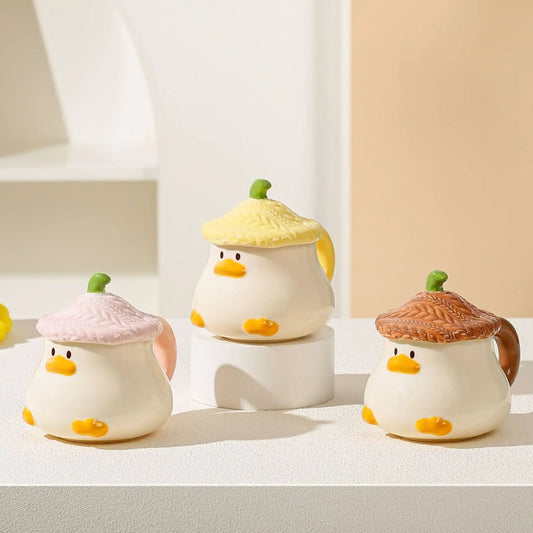 Kawaii Duck Mugs with lids on a countertop