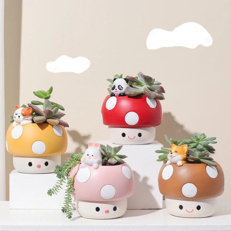 Set of four mushroom-shaped planters with succulents against a light background