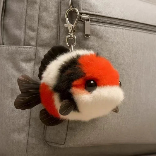 Plush Koi fish keychain attached to a gray bag
