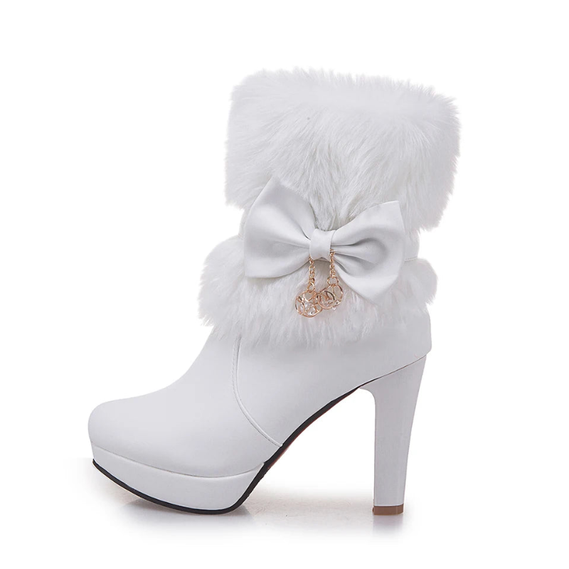 White boot with fur and bow detail on a white background