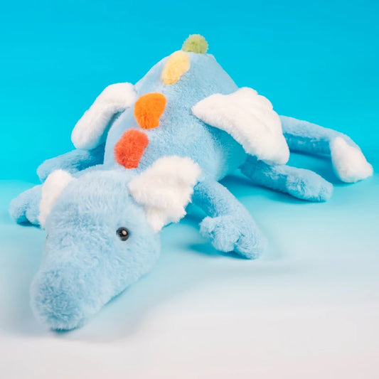 Blue plush dragon toy with colorful accents on a blue background