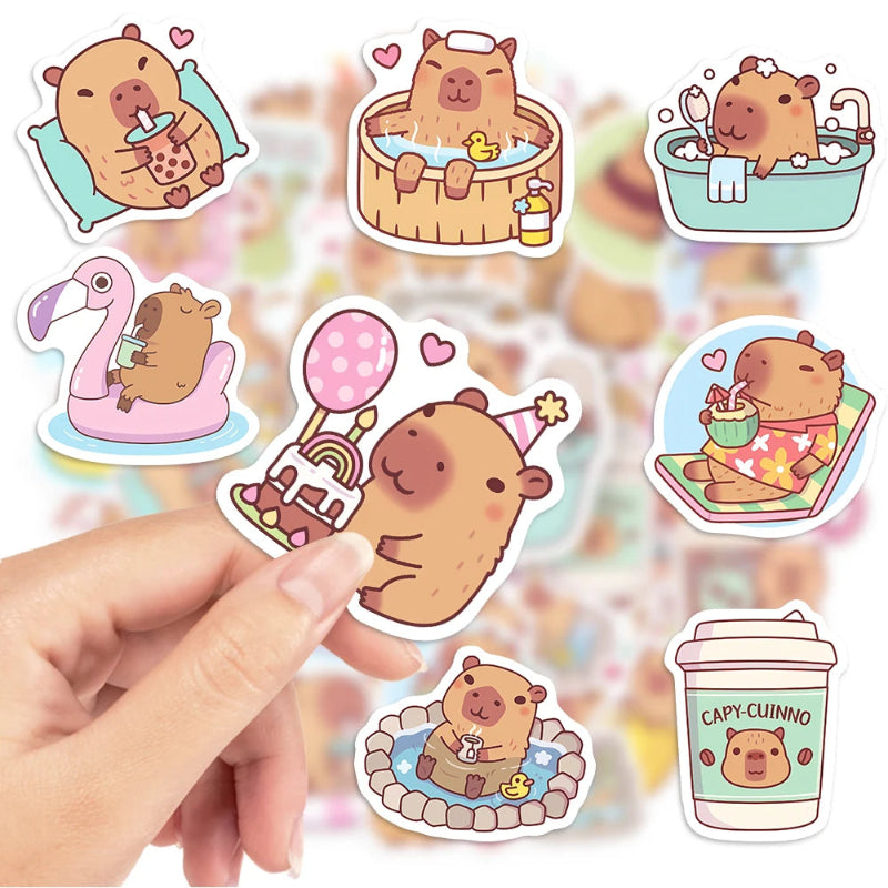 Set of cute capybara-themed stickers featuring a hand holding one of them.