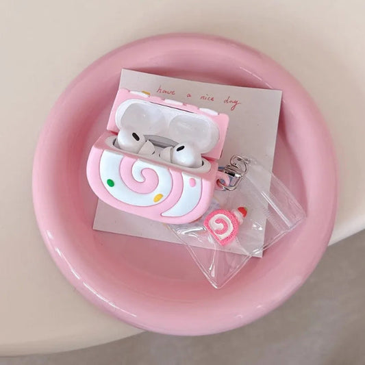 Pink swiss roll shaped air pod case on a pink plate