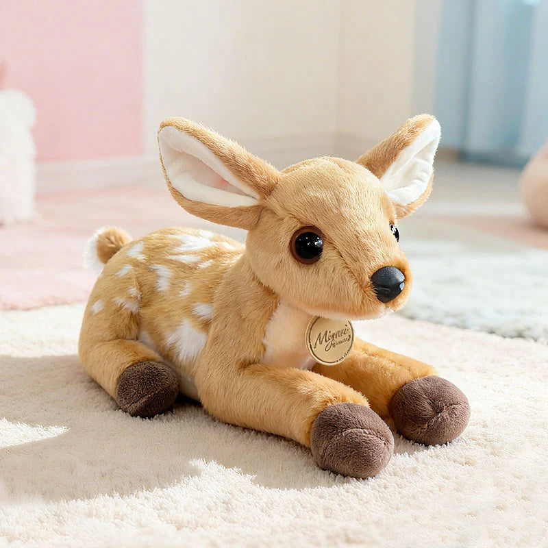 Plush deer toy on a soft surface with a blurred background