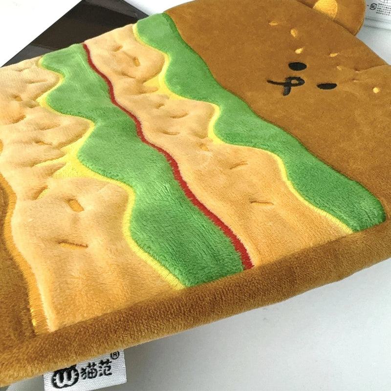 Plush tablet sleeve resembling a hamburger with mustard and ketchup on a white background