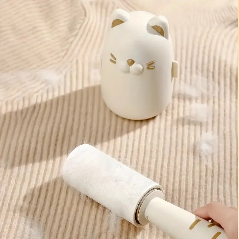 White cat-shaped roller with a hand holding it on a textured beige surface