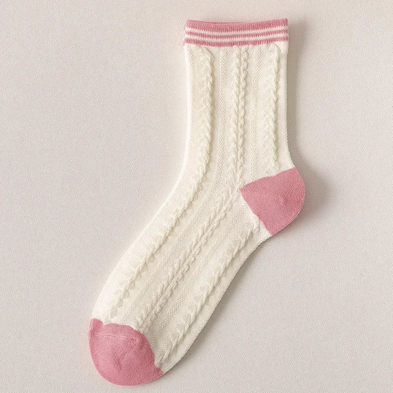 White sock with pink accents on a light gray background