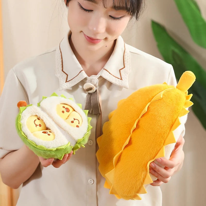 Person holding a plush toy resembling a durian fruit with a smiling face.