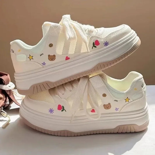 Kawaii white sneakers with colorful designs on a light background