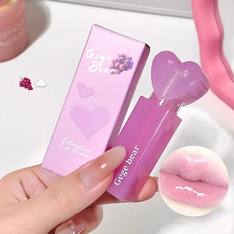 Pink lip balm with 'Gege bear' branding held by a hand, with a matching pink box in the background.