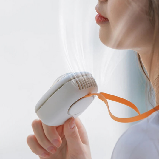 Woman using a white cooling device with an orange strap on a light background.