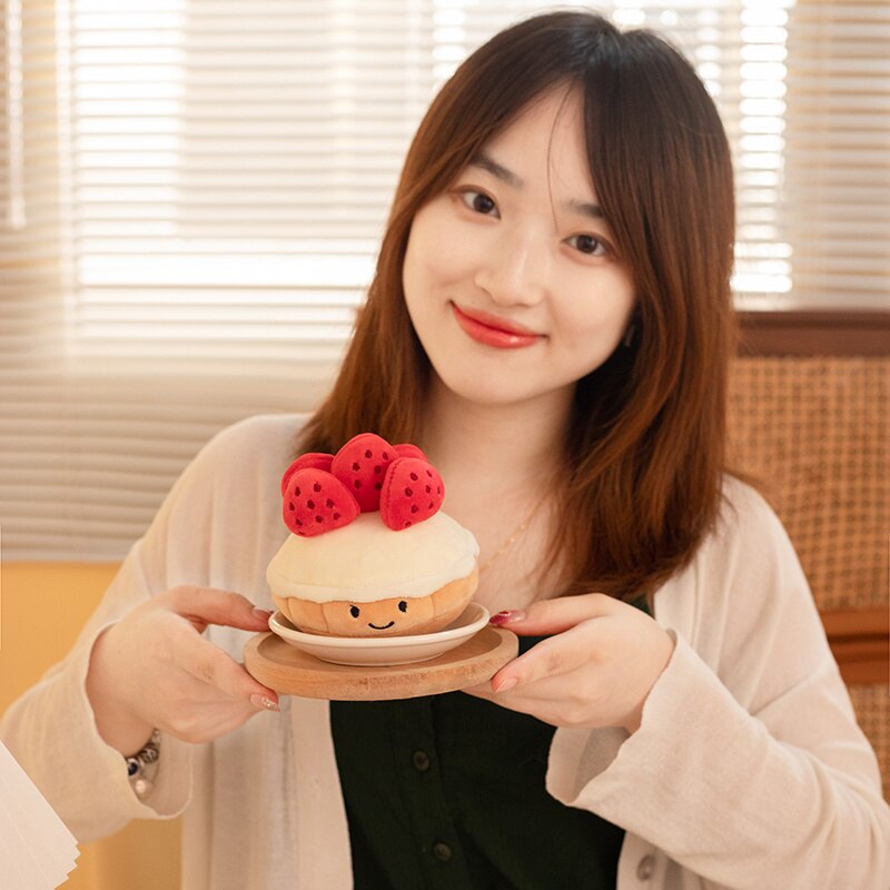 Model Holding Kawaii Strawberry Cake Plushie on a Plate