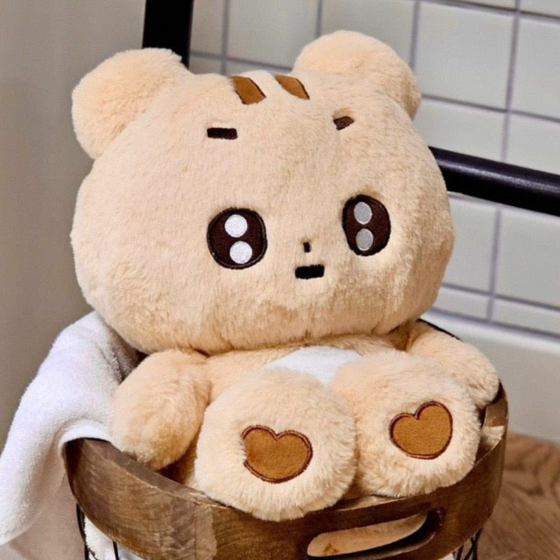 Plush toy bear with heart details on a chair