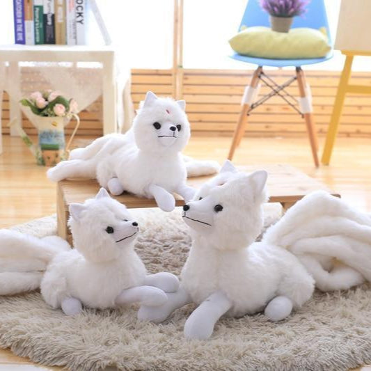 Three Kitsune Plushies on a Rug