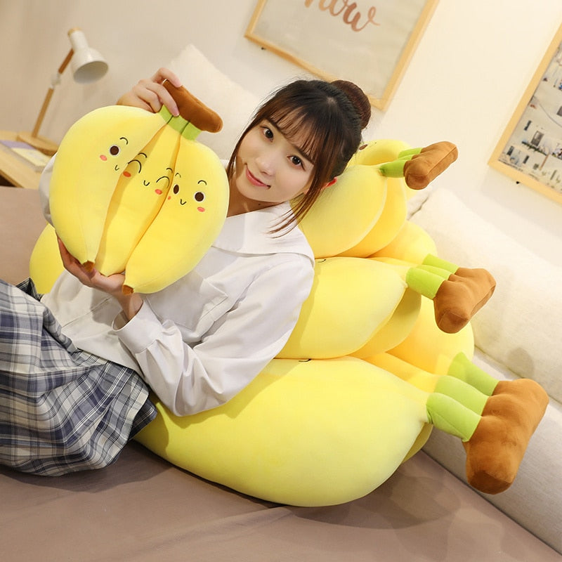 Girl Holding and reclining against Kawaii Banana Bunch Plushies