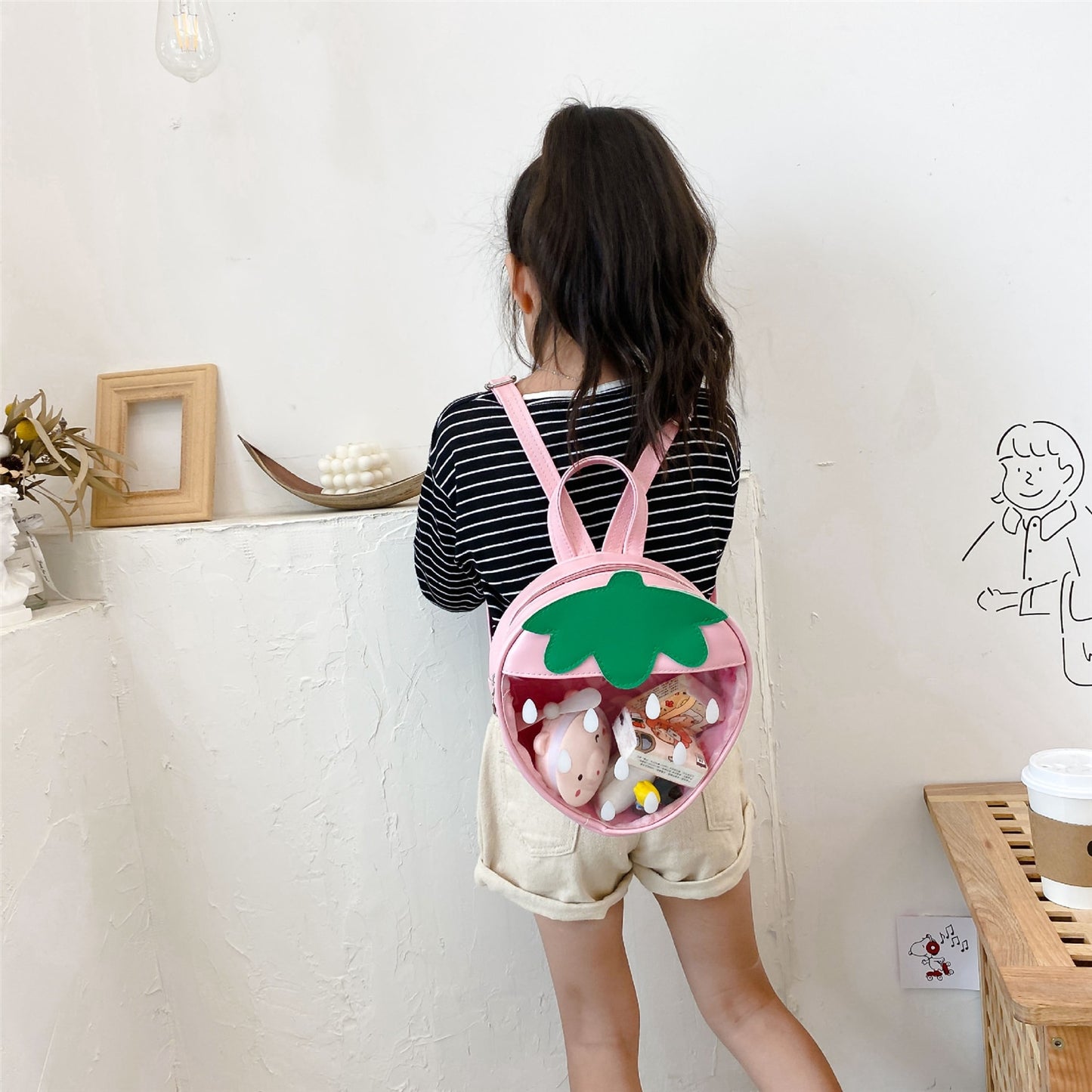 Girl wearing Kawaii Transparent Strawberry Backpack in pink